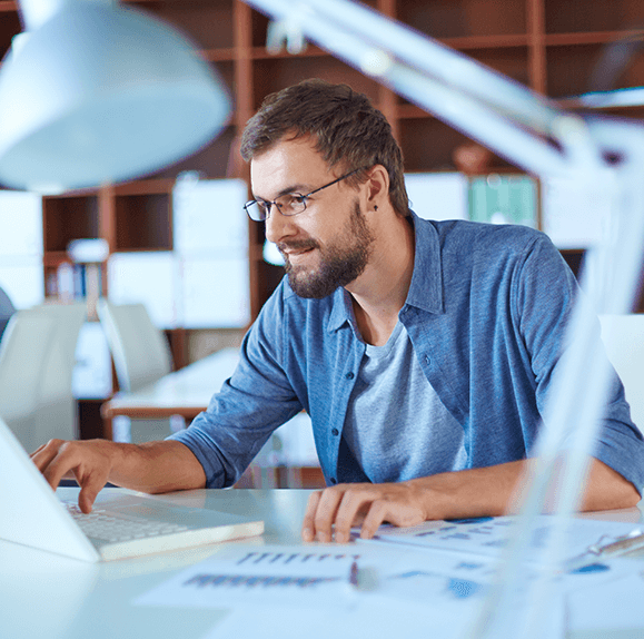 man looking at laptop exploring SummitAI IT asset management solutions