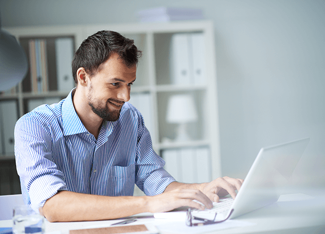 man looking at laptop exploring SummitAI IT asset management solutions