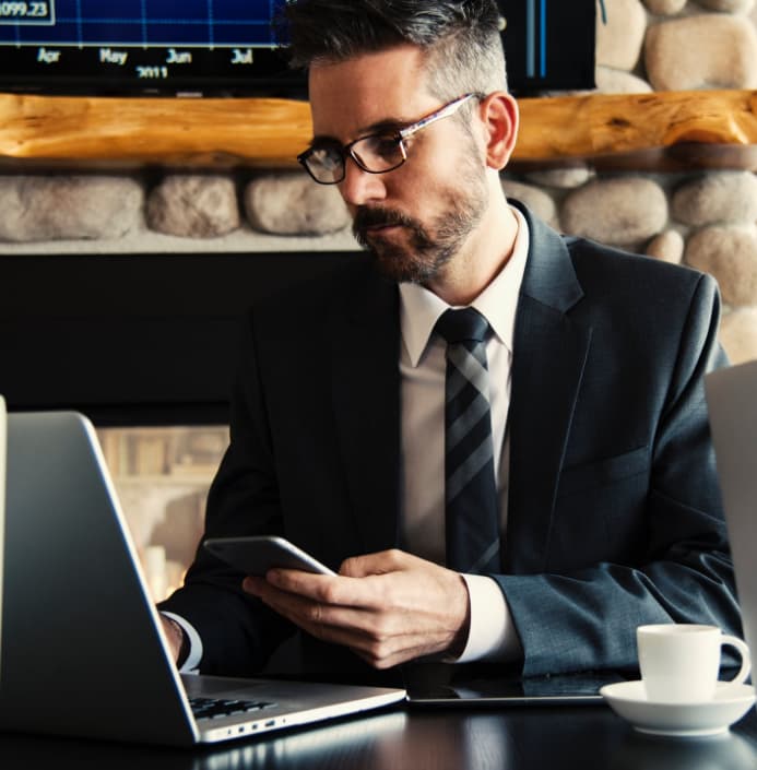 man looking at laptop exploring SummitAI IT asset management solutions